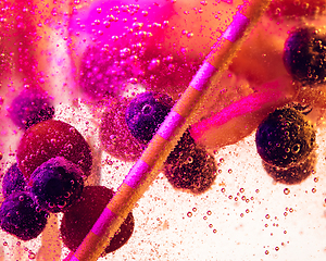 Image showing Close up view of the cold and fresh lemonade with bright berries in neon light