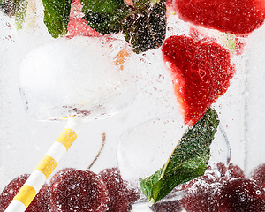 Image showing Close up view of the cold and fresh lemonade with bright berries in neon light