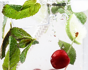 Image showing Close up view of the cold and fresh lemonade with bright berries in neon light