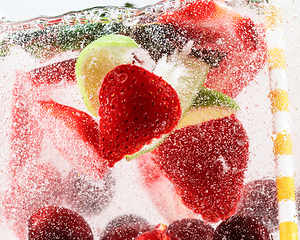 Image showing Close up view of the cold and fresh lemonade with bright berries in neon light