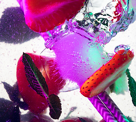 Image showing Close up view of the cold and fresh lemonade with bright berries in neon light