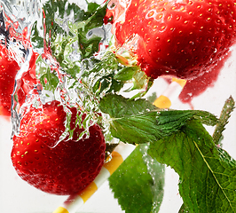 Image showing Close up view of the cold and fresh lemonade with bright berries in neon light