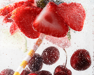 Image showing Close up view of the cold and fresh lemonade with bright berries in neon light