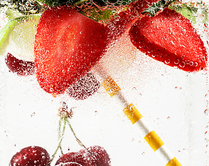 Image showing Close up view of the cold and fresh lemonade with bright berries in neon light