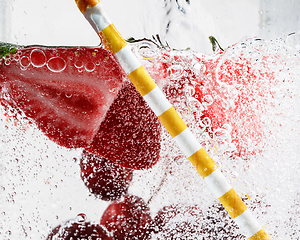 Image showing Close up view of the cold and fresh lemonade with bright berries in neon light