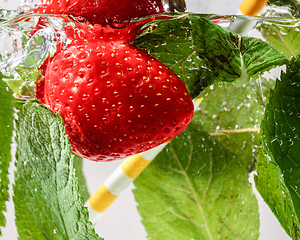 Image showing Close up view of the cold and fresh lemonade with bright berries in neon light