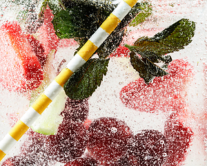 Image showing Close up view of the cold and fresh lemonade with bright berries in neon light