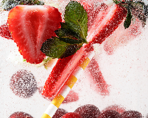 Image showing Close up view of the cold and fresh lemonade with bright berries in neon light