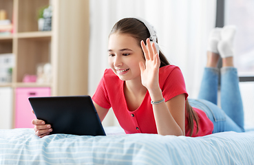 Image showing girl having vide call on tablet computer at home