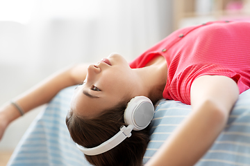 Image showing girl in headphones listening to music at home