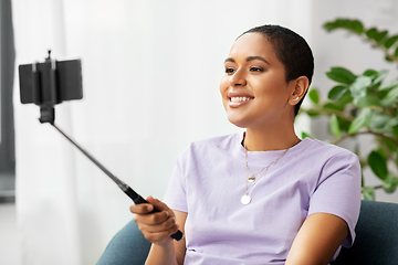 Image showing happy african american woman taking selfie at home