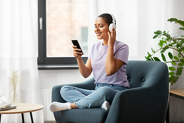 Image showing woman with smartphone listening to music at home