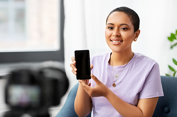 Image showing female blogger with camera video blogging at home