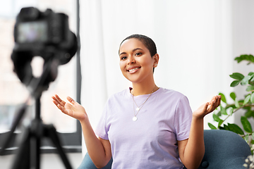 Image showing female blogger with camera video blogging at home