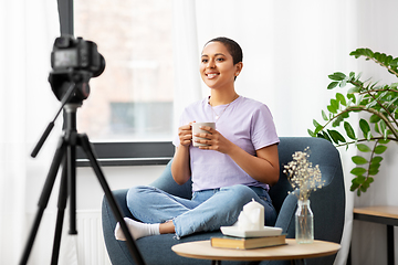 Image showing female blogger with camera and coffee at home