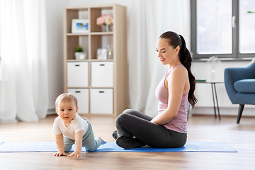 Image showing happy mother with little baby at home