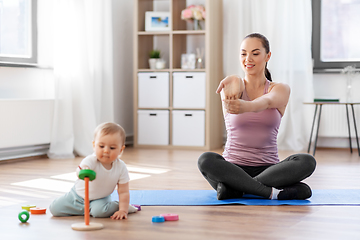 Image showing happy mother with little baby exercising at home