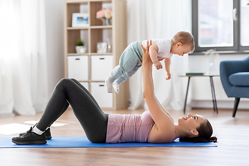 Image showing happy mother with little baby exercising at home