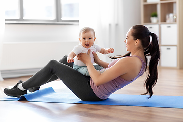 Image showing happy mother with little baby exercising at home