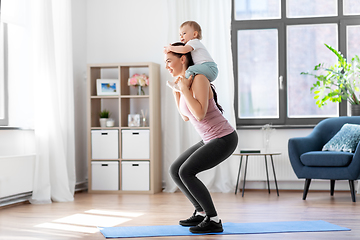 Image showing happy mother with little baby exercising at home