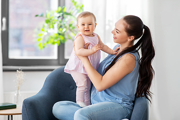 Image showing happy mother with little baby daughter at home