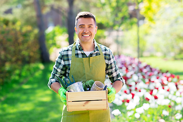 Image showing happy man with tools in box at summer garden
