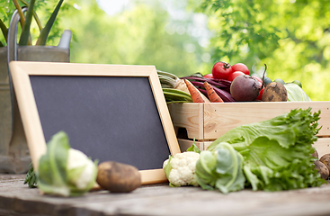 Image showing close up of vegetables with chalkboard on farm