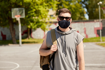 Image showing man with backpack at street basketball playground