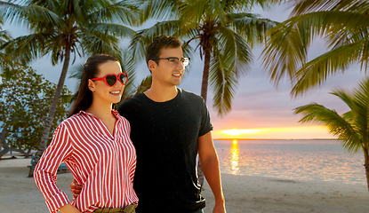 Image showing happy couple walking along summer beach