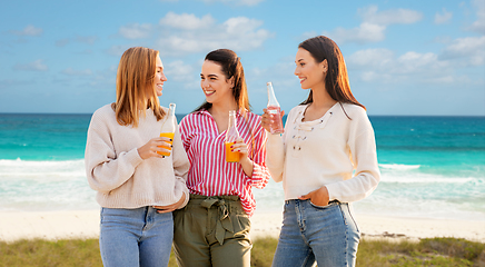 Image showing young women with non alcoholic drinks on beach