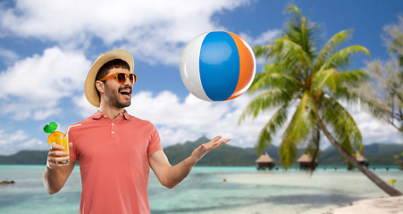 Image showing happy man with orange juice and beach ball