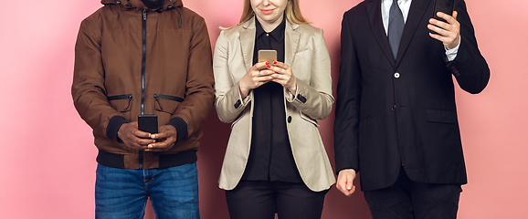 Image showing Group of friends using mobile smartphones. Teenagers addiction to new technology trends. Close up.