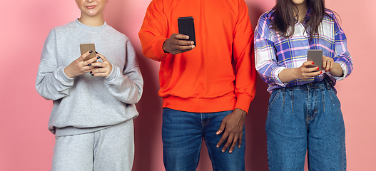 Image showing Group of friends using mobile smartphones. Teenagers addiction to new technology trends. Close up.