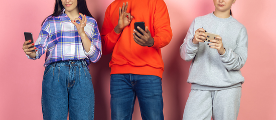 Image showing Group of friends using mobile smartphones. Teenagers addiction to new technology trends. Close up.