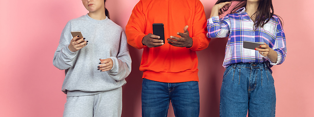 Image showing Group of friends using mobile smartphones. Teenagers addiction to new technology trends. Close up.