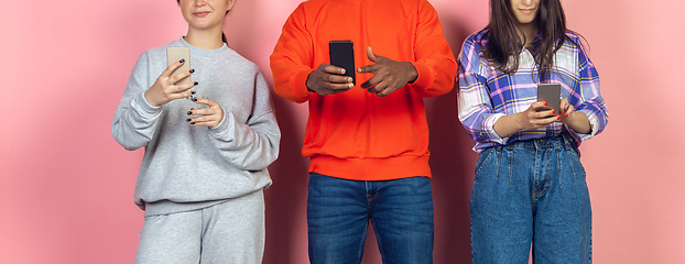 Image showing Group of friends using mobile smartphones. Teenagers addiction to new technology trends. Close up.