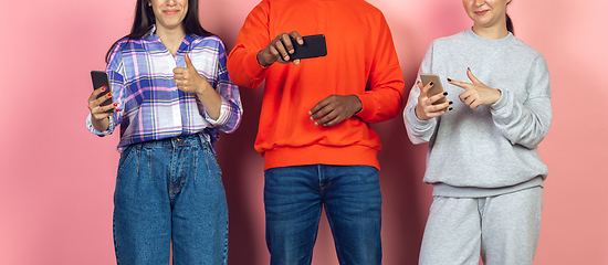 Image showing Group of friends using mobile smartphones. Teenagers addiction to new technology trends. Close up.