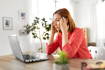 Image showing stressed woman with laptop working at home office