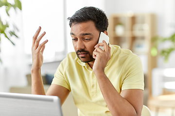 Image showing man calling on smartphone at home office