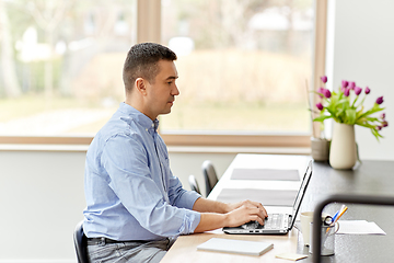 Image showing man with laptop working at home office