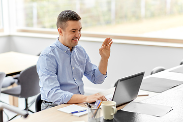 Image showing man with laptop having video call at home office