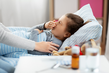 Image showing mother and sick little daughter in bed at home