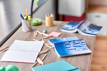 Image showing school supplies scattered on table at home