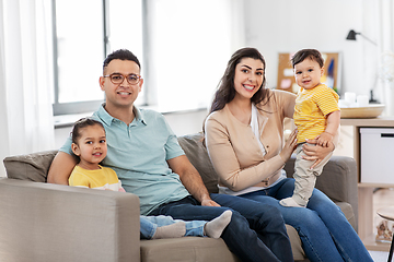 Image showing portrait of happy family sitting on sofa at home