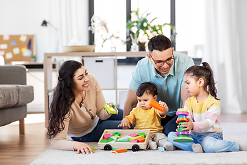 Image showing happy family palying with wooden toys at home