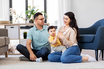 Image showing happy family with child sitting on floor at home