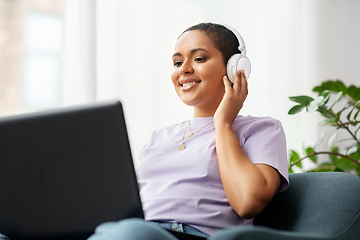 Image showing woman with laptop listening to music at home