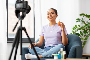 Image showing female beauty blogger with camera and cosmetics