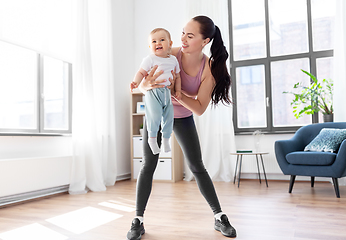 Image showing happy mother with little baby exercising at home