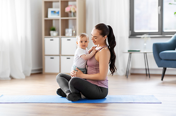 Image showing happy mother with little baby at home